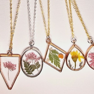 Pressed real flower resin necklaces. Handmade picked and pressed flowers.